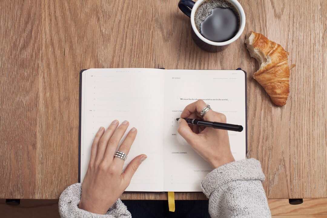person writing in journal